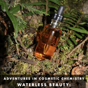 A clear dropper bottle filled with amber liquid cradled by moss, leaves, and ferns.